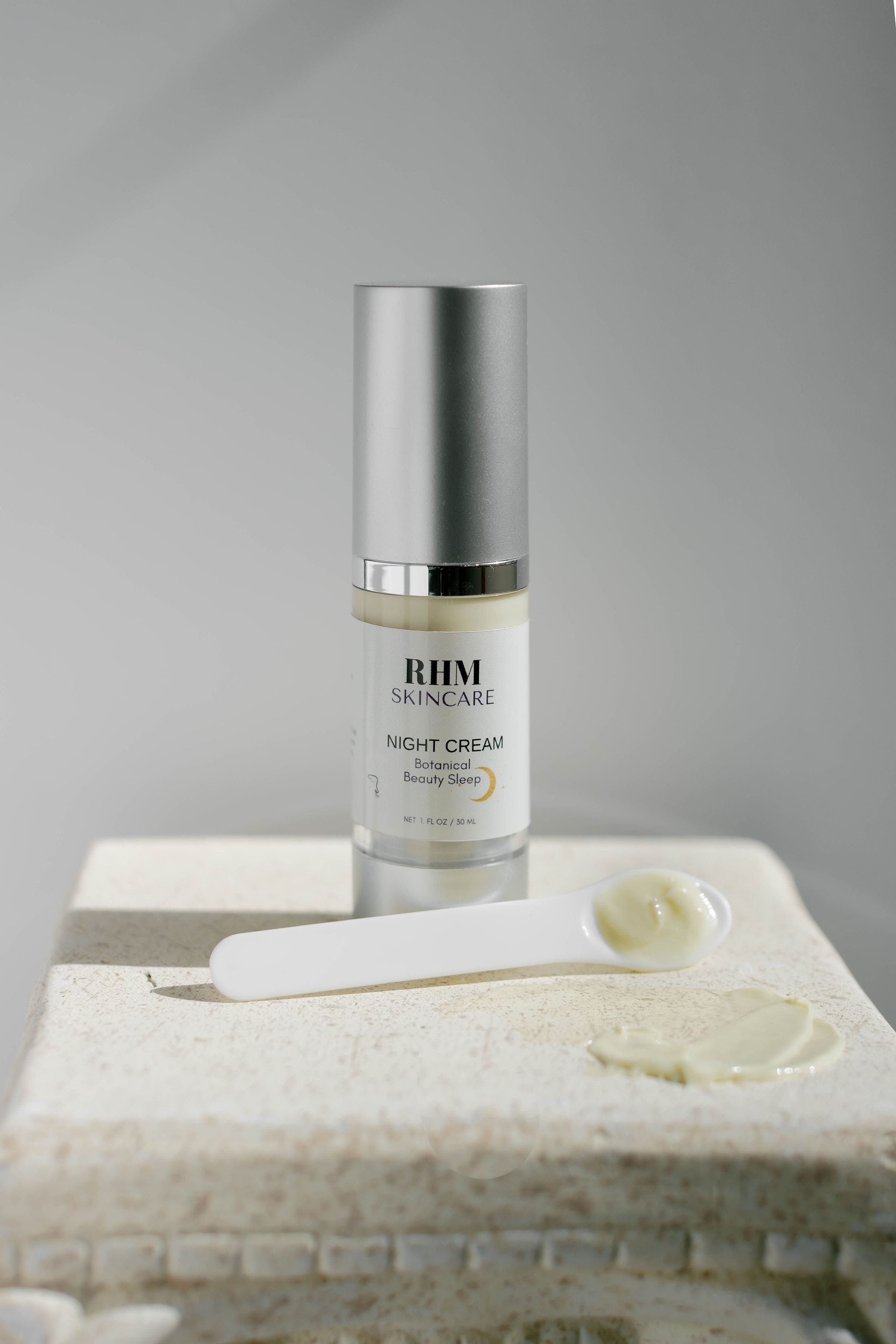 RHM Night Serum on dark surface